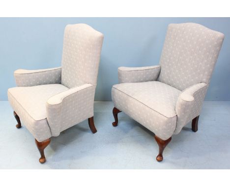 A pair of stained wood armchairs, each with light blue, floral fabric upholstery. 93cm high.
