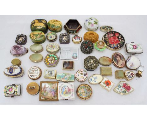 A large collection of various pill boxes, including examples made of ceramic, gilt, enamel and more