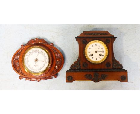 A stained wood mantel clock by 'Chapman,' the white dial with Roman numerals denoting hours and the case with ornate applied 