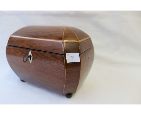 A 19th century walnut tea caddy, of domed oval form with boxwood inlay, enclosing two lidded compartments on ball feet, 21cm 