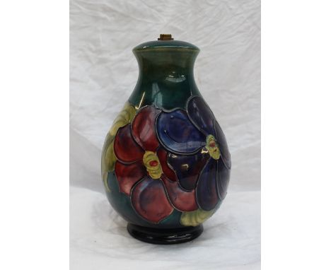 A Moorcroft pottery table lamp base decorated in the Clematis pattern to a graded green ground, impressed mark CONDITION REPO