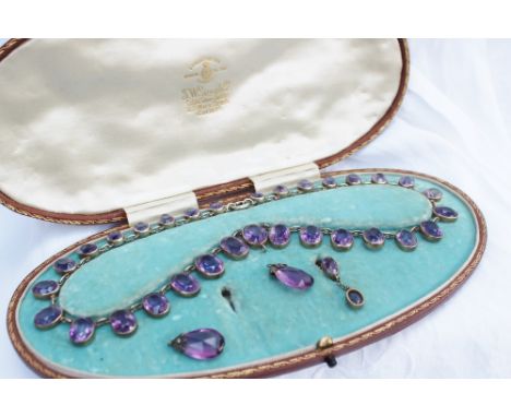An early 20th century amethyst fringe necklace, set with 31 oval faceted amethysts ranging in size from 8mm to 11mm in yellow