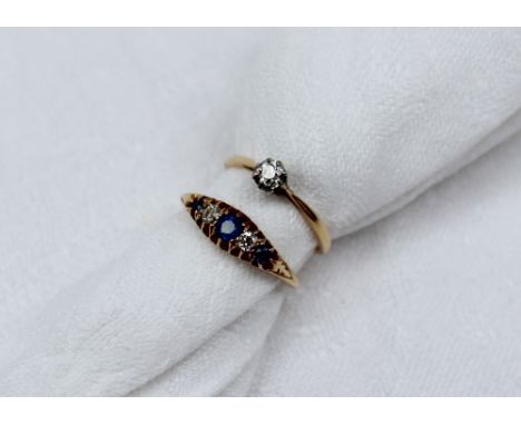 A sapphire and diamond gypsy ring set with three light blue sapphires and two old cut diamonds to an 18ct yellow gold shank, 