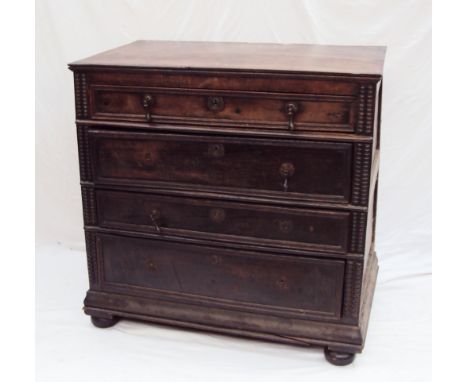 An 18th century oak chest of drawers, the rectangular planked top above four long graduated drawers with half section reel mo
