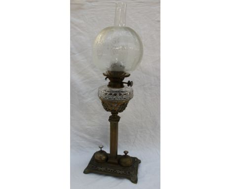 A Rippingille's patent brass and glass oil lamp, the etched globe shade with a cut glass reservoir seated in a brass base wit