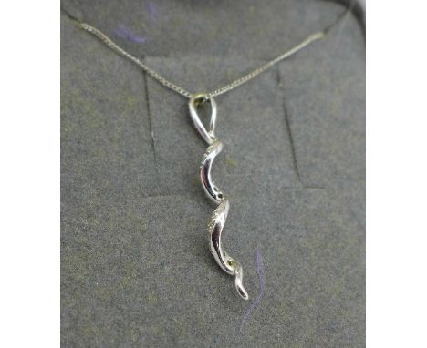 A 9ct white gold and diamond pendant and chain, 1.6g