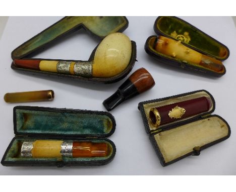 A French gold mounted sherry amber cheroot holder, cased, a Victorian silver mounted cheroot holder, Birmingham 1900, cased, 