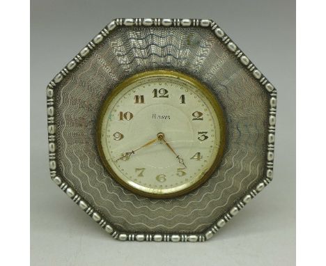 A white metal mounted 8 days clock, tests as silver, glass a/f