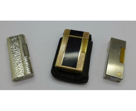 Two Dunhill lighters, no boxes and a Dupont lighter with leather case