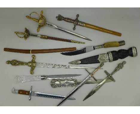 A collection of letter openers, one in the form of a Japanese sword, one with blade marked Wilkinson, and a Celtic type dagge