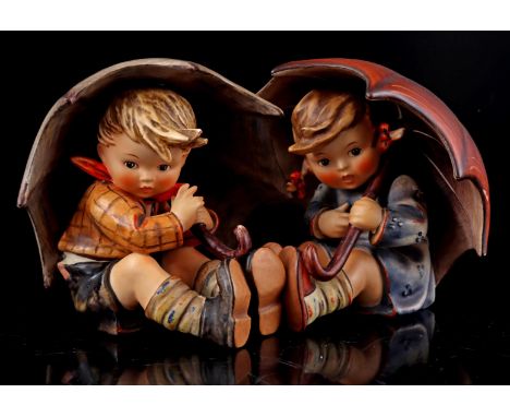 2 Goebel Hummel earthenware statues of a girl and boy under umbrella, numbers 152/08 and 152/0A, 12 cm high