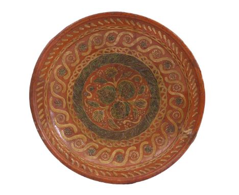 Earthenware dish with polychrome relief mud decor of flowers and pomegranates in shelf and patterns in edge, Holland early 17