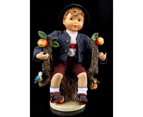 Goebel Hummel porcelain statue of a boy sitting in the apple tree, entitled 'Apple tree boy', Hum 951, 34 cm high, 24 cm wide