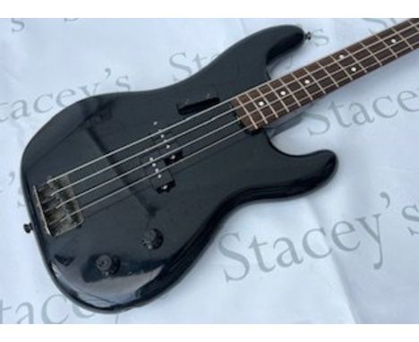 A 1986 Fender Japan Precision Bass Guitar in Black.In fair to good condition overall. Some light marking, scratches and playw