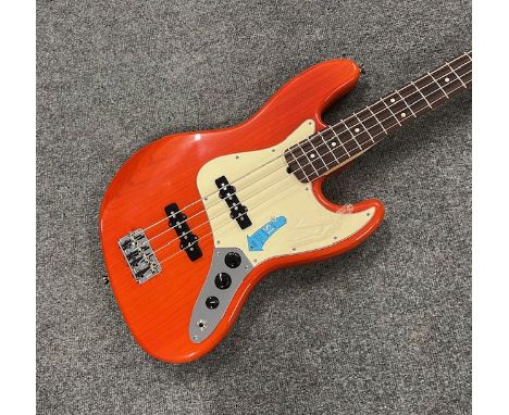 A Fender Jazz Bass Guitar Made in USA 2005 with Rosewood Fingerboard in Sunset Orange Transparent finish . Condition is as ne