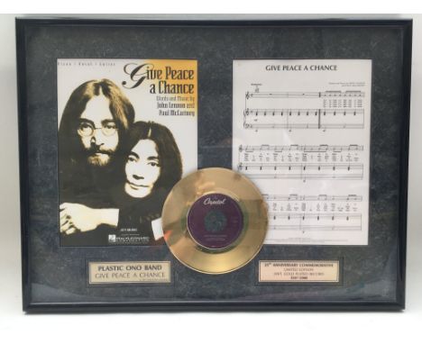 A framed and glazed limited edition gold disc display commemorating the 25th anniversary of 'Give a Peace A Chance' by Plasti