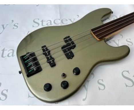 A 1989 Fender Japan Fretless Jazz Bass Guitar in Jade Pearl Metallic - some playwear and light marking consistent with age an