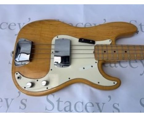 A 1973 all original Fender Precision Bass Guitar in natural finish with white pick guard aged to cream. Light crazing to body