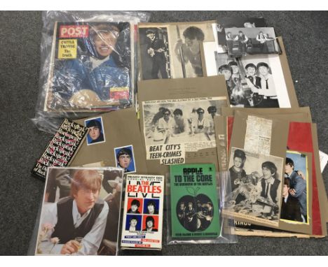 A box of music memorabilia including an Elton John autograph, Debbie Harry autograph, Beatles scrapbook pages, John Peel pres