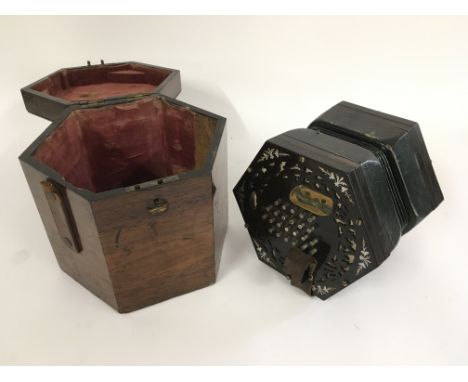 A fine quality concertina with original fitted wooden case. Label sadly illegible.