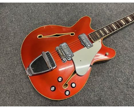 A 1967 Fender Coronado II 6 string electric guitar. Candy Apple Red metallic with matching headstock. Finish has aged with ye