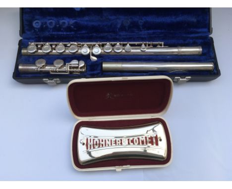 A cased flute and a cased Hohner Comet harmonica (2).