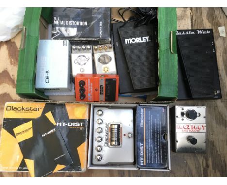 A box of guitar pedals including a a Boss CE-5, Electro Harmonix Hog's Foot bass booster, Blackstar HT-DIST and others.