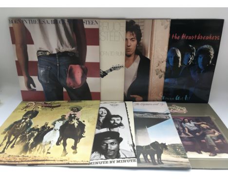 Two bags containing 16 LPs by various artists including Bruce Springsteen, Neil Young, Bob Dylan and others.