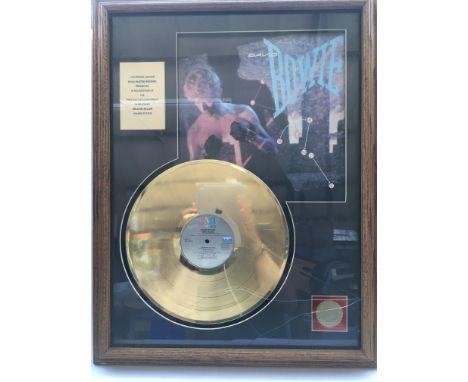 A framed David Bowie gold disc presented in recognition of a million sales of the 'Lets Dance' LP, approx 52.5cm x 68cm. Glas