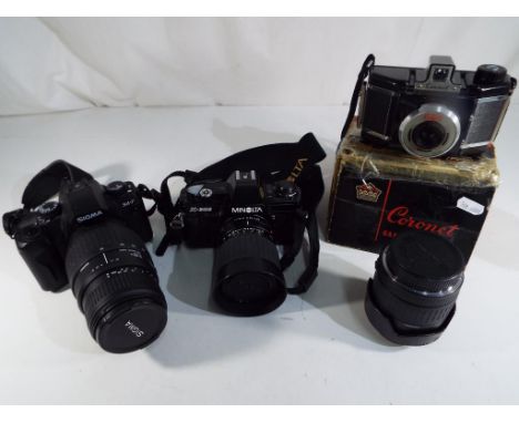 Two cameras comprising Sigma and Minolta with zoom lens, model 1219173  Dimarco-Super and 1005456 with carry cases and access