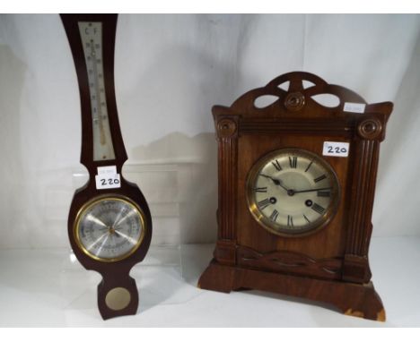 A good quality oak cased mantel clock and a wall barometer (2)