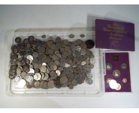 A quantity of UK and foreign coins to include pre and post decimal, a Rhodesian Independence commemorative medallion and othe