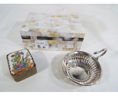 A good quality mother of pearl trinket box, height 6.5 cm x 16 cm x 10.5 cm, a white metal bowl with handle in the form of a 
