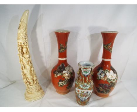 A pair of Japanese vases with fluted necks decorated with flowers and butterflies on a burnt orange ground approximate height