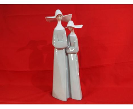 Lladro - a Lladro figural group depicting two nuns, approximate height 32 cm. Estimate £20 - £30