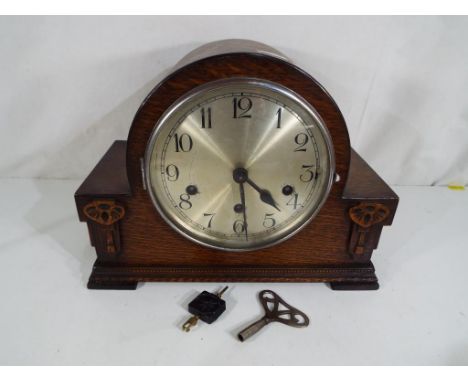 A good quality oak cased mantel clock with Westminster chime, pendulum and key
