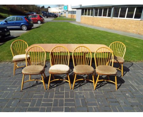Ercol - an Ercol Windsor refectory / dining table with six hoop-backed chairs with detachable cushion seats, the table measur