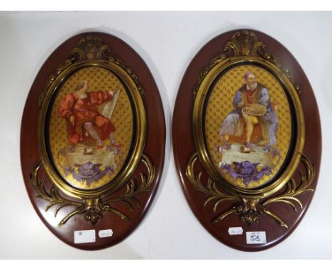 Two ceramic wall plaques decorated with images of artists with brass surrounds mounted on oval wooden boards (2)