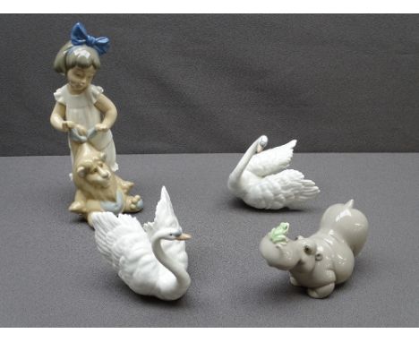 NAO - a young girl with a lion, a hippo with a frog on its nose and a pair of Lladro white swans