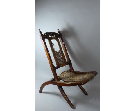 A Late Victorian Mahogany Folding Chair with Carved and Pierced Top Rail and Caned Seat and Back Rest, (Requires Attention) 