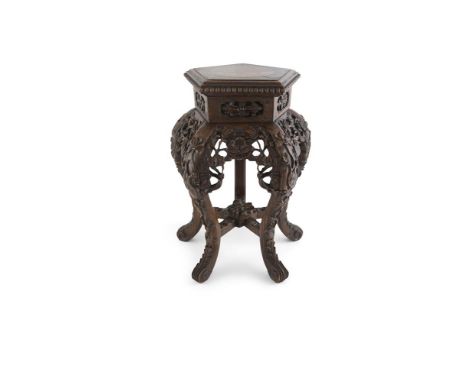 A CHINESE CARVED CHERRYWOOD PENTAGONAL JARDINIÈRE STAND, the top with inset marble and raised on heavily carved and pierced a