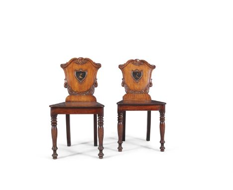 A PAIR OF VICTORIAN MAHOGANY SHIELD BACK HALL CHAIRS, the scroll back cresting carved and painted with crests to backs, over 