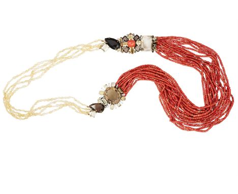 A LONG CORAL AND QUARTZ NECKLACE BY IRADJ MOINI, composed of sixteen strands of graduated series of cylindrical coral coralli