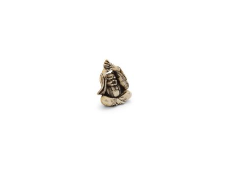 A JAPANESE CARVED IVORY NETSUKE, 19th century, modelled on of the form of an oni, in a seated position with raised arms, dres