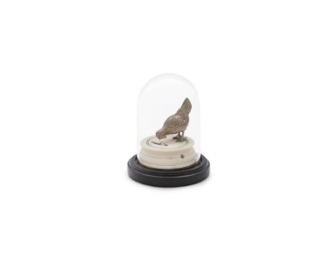 A MINIATURE WHITE METAL MODEL OF A CHICKEN PECKING AT A WORM, mounted on a circular ivory base twisting open to reveal the ch