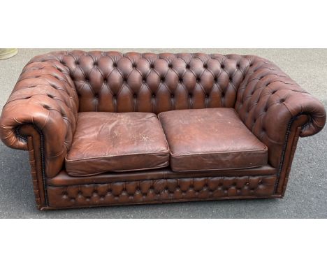 Vintage 2 seater chesterfield sofa, worn sections, missing castor to back, approximate measurements: Height 25.5 inches, Leng