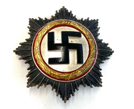 German gold cross medal, with black enamel Swastika on a frosted silver ground, framed within a gold wreath made by Zimmerman