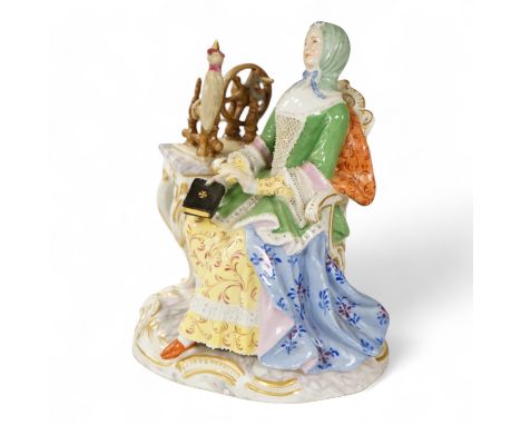 A Meissen style figure of a seated lady at her spinning wheel, 15.5cm high.