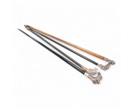 Four 19th century and later walking sticks with silver and white metal tops, to include three horse racing interest examples,