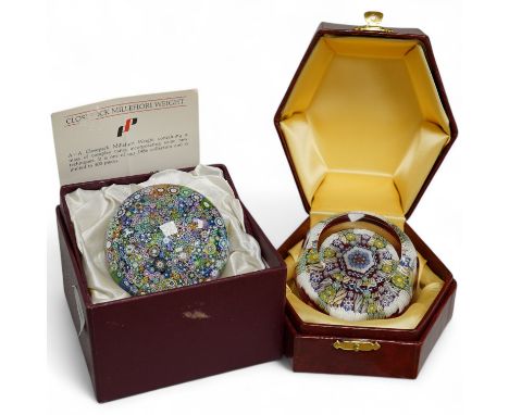 Two boxed Perthshire glass paperweights, the first faceted with latticino twists and complex canes, the second close packed m
